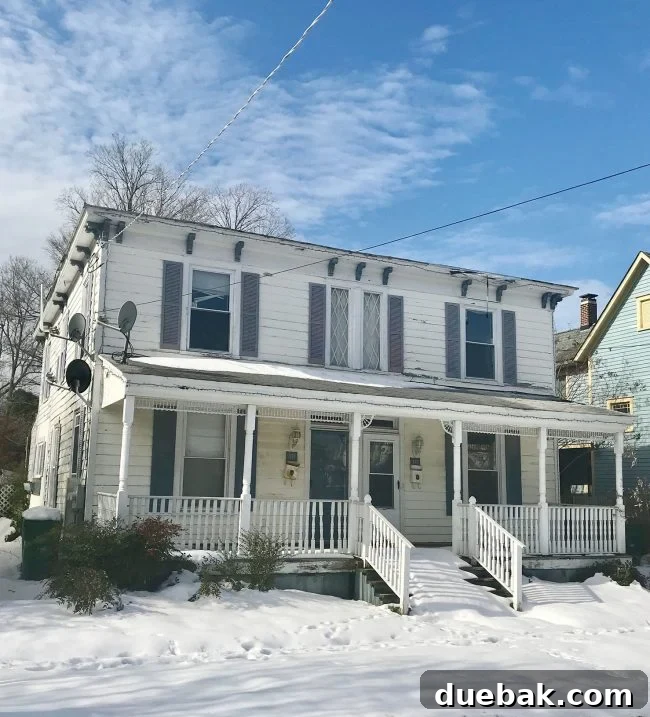 Renovation Rage 6 Before photo of a historic home in Cape Charles Virginia covered in snow, emphasizing its need for renovation
