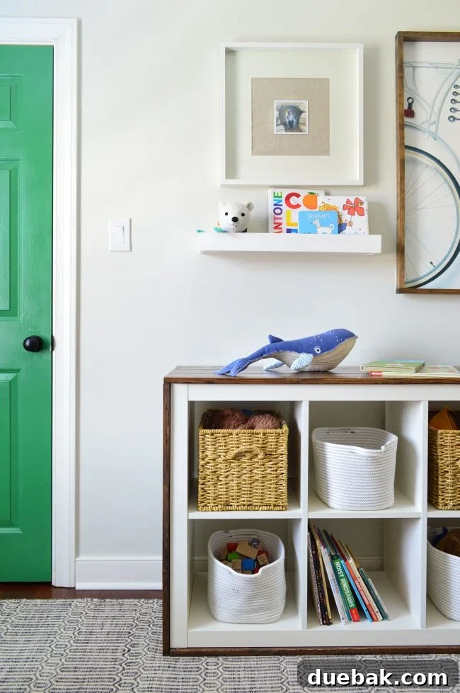 Transforming Our Son's Space 13 Wall shelf with books and a Pottery Barn Kids whale decor