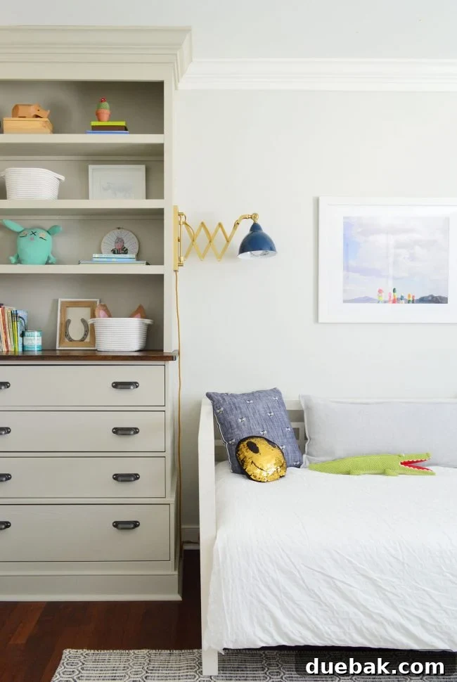 Transforming Our Son's Space 4 Detailed shot of the daybed with bee pillows and a sconce