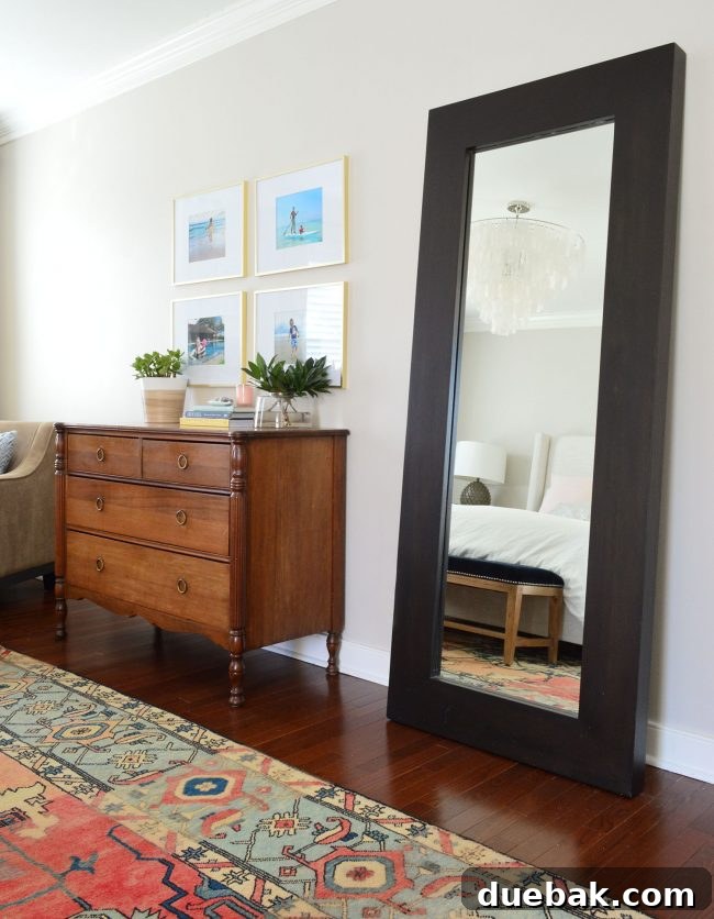 Large leaning mirror in a bedroom, reflecting natural light.