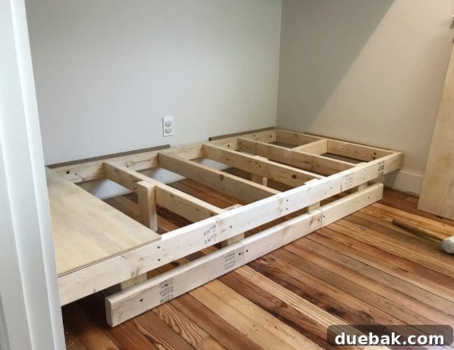 Constructing Bespoke Bunk Beds 11 The bottom bunk platform meticulously reconstructed to float off the floor, revealing added 2x4 legs and a front 2x2 support for baseboard.