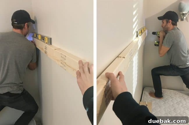 Constructing Bespoke Bunk Beds 14 John demonstrating the force required to drive RSS screws securely into a 2x4, anchoring it to the wall for the top bunk.