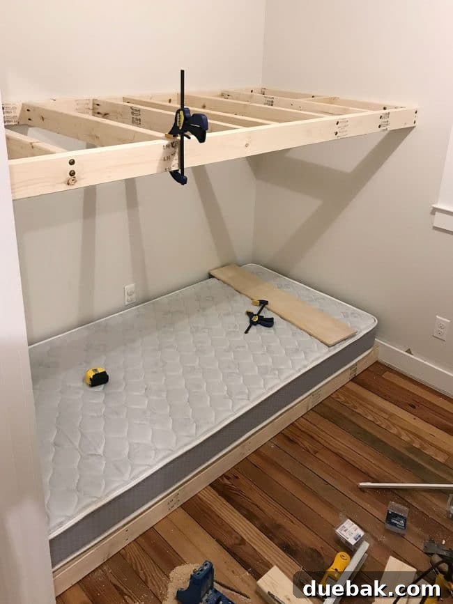 Constructing Bespoke Bunk Beds 15 The top floating bunk platform securely added to the wall-to-wall bunk bed frame, demonstrating its robust, integrated construction.