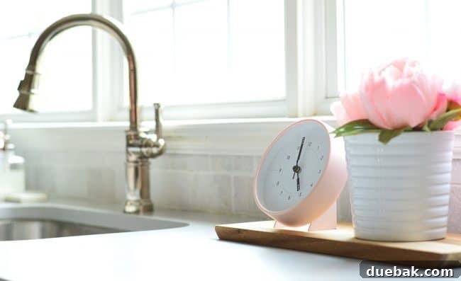 Pink tabletop clock in a kitchen setting