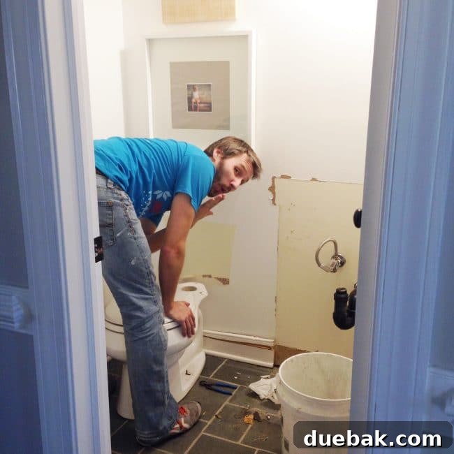 Person pausing during bathroom demolition