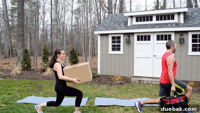 A person doing lunges while holding a box of tiling supplies.