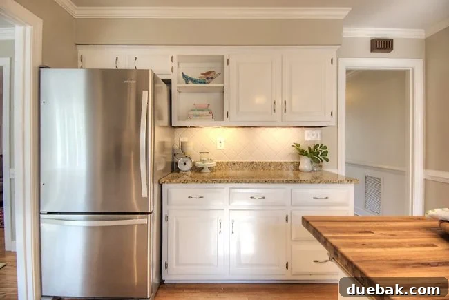 Home Staging Tips: Sell Your House or Simplify Your Life 19 painted kitchen cabinets and clean stainless steel refrigerator, emphasizing clean lines