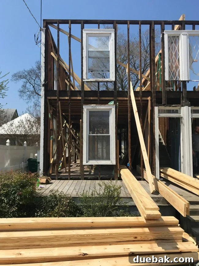 Exposed hardwood floors in the duplex during demolition, showing their raw state