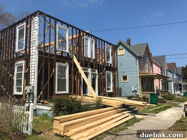 Exterior of the duplex showing missing siding and exposed structural elements