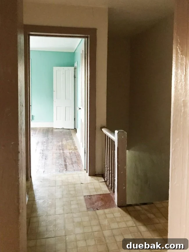 Bedroom floor showing sticky residue from old vinyl tiles covering hardwood