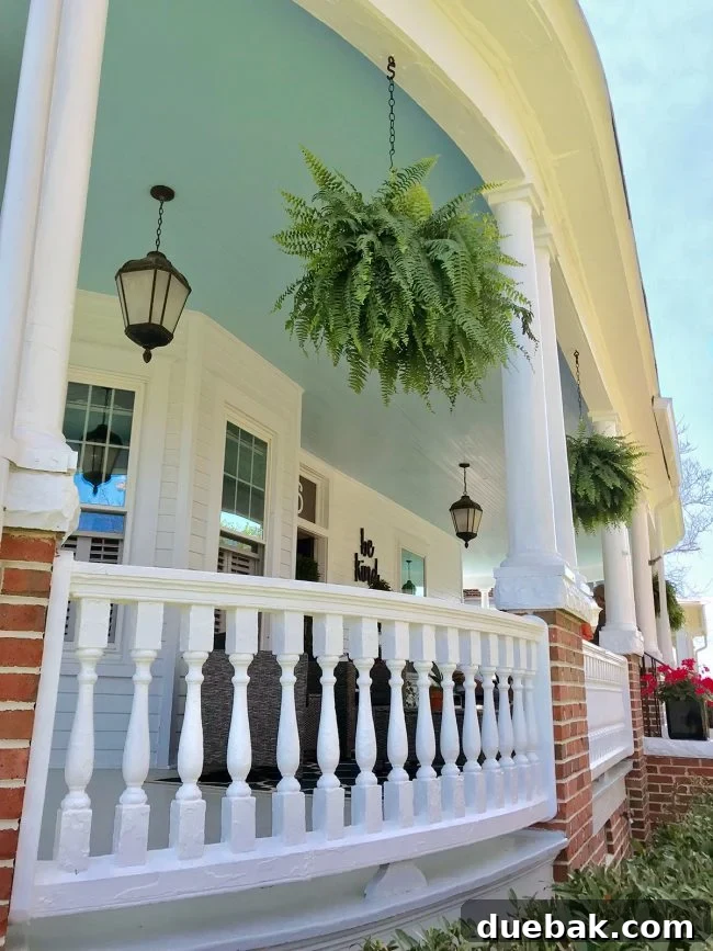 A charming house in Cape Charles featuring a beautiful curved wraparound porch