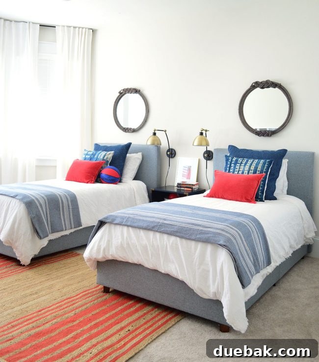 J's sporty and calming bedroom with gray upholstered beds and red accents