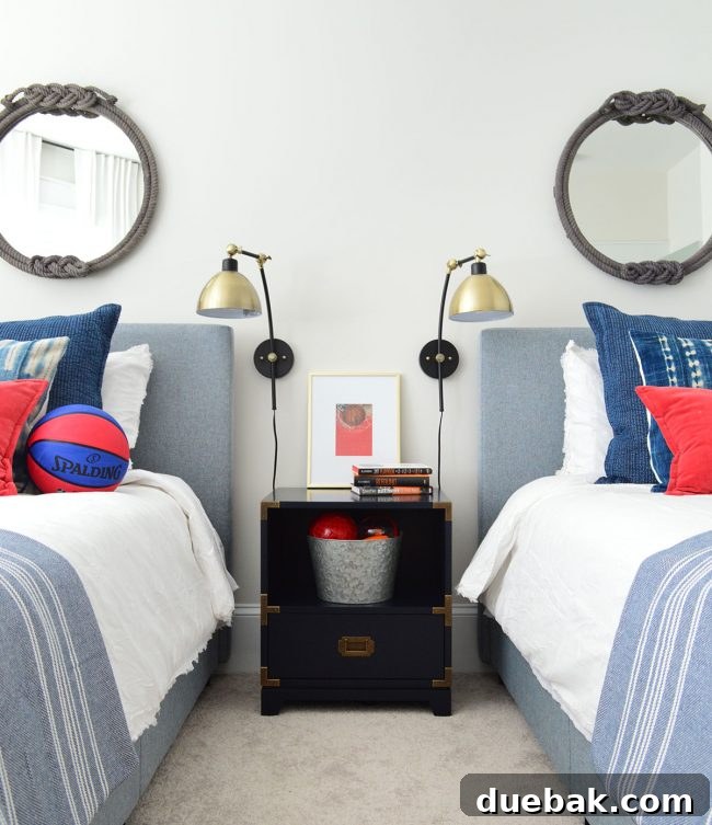 J's bedroom with two upholstered beds, a nightstand, and wall sconces, showcasing design flexibility