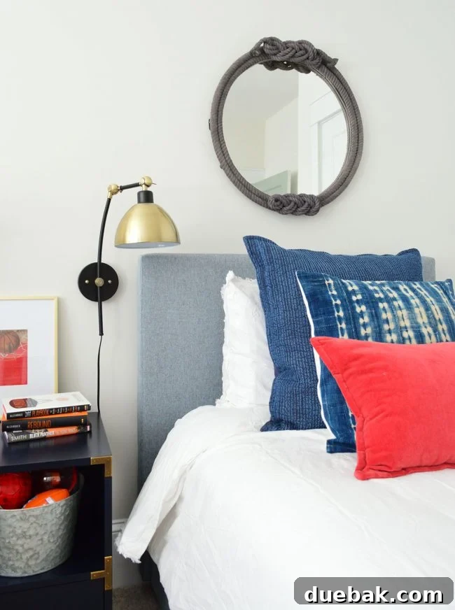 Close-up of a stylish plug-in wall sconce in J's bedroom, highlighting practical design