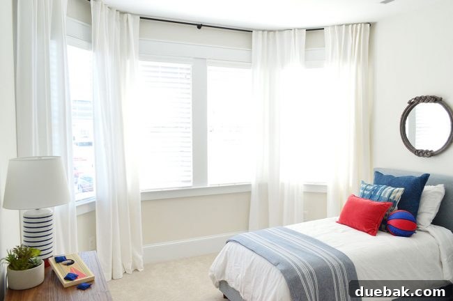 After photo of J's bay window with a continuous curtain rod across all three sections, creating a seamless look