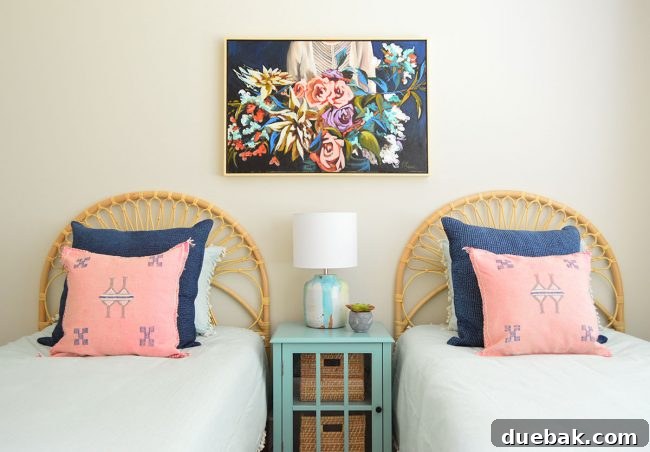 Large painting by Stacey Reece above beds in S's room, with navy and pink pillows