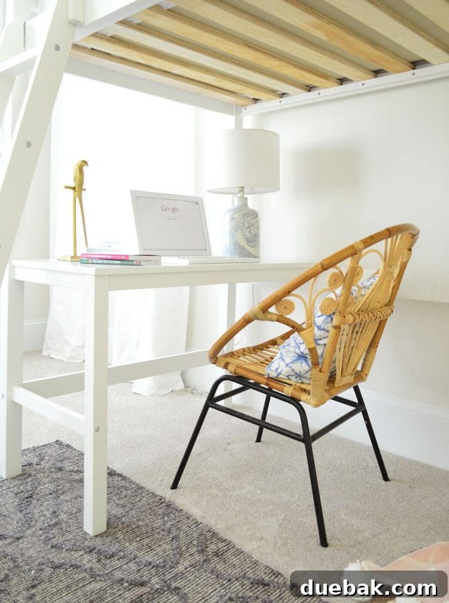 Desk area under A's loft bed with a fun chair and a swirly table lamp