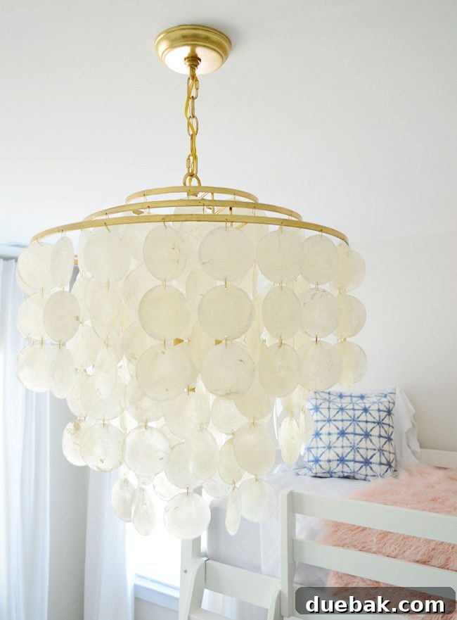 Close-up of the elegant tiered capiz chandelier in A's bedroom, designed by Young House Love