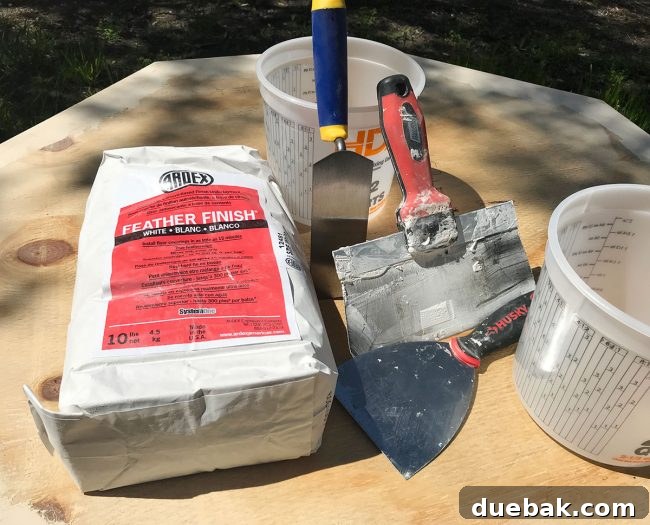 Tools for applying Ardex Feather Finish: trowels, buckets, sander