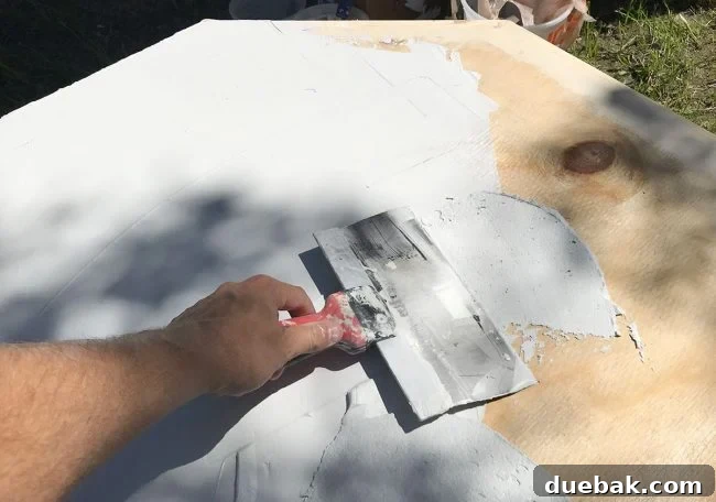 Spreading the first coat of Ardex Feather Finish onto the tabletop