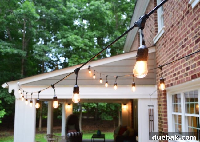 The White Brick House Dilemma 6 Fiet Electric 48ft Indoor/Outdoor String Lights illuminating a back patio space.