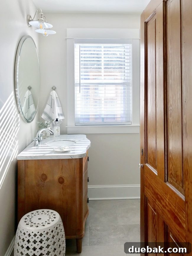 Hall bathroom with blue accent tile partially hidden