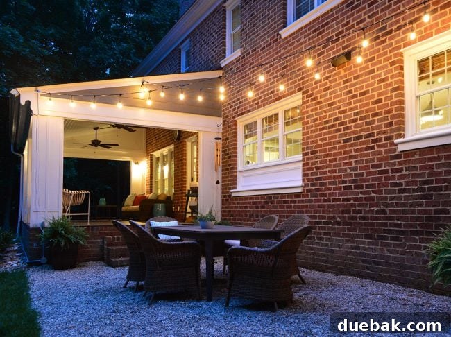 Out With the Deck, In With a Pea Gravel Patio 19 The illuminated pea gravel patio at dusk, showing the warm glow of the garden string lights.