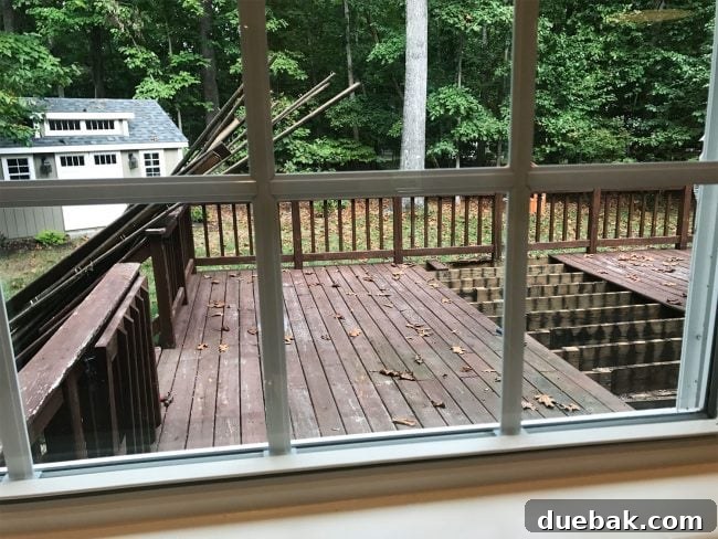 Out With the Deck, In With a Pea Gravel Patio 5 Partial view of the deck removal process, with some boards already taken off the house.