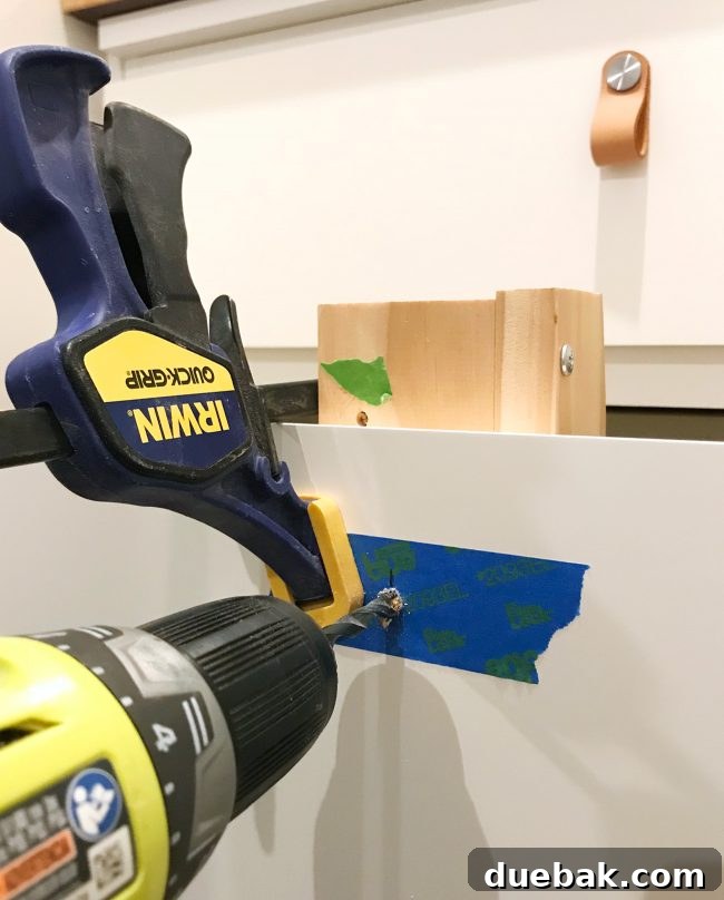Seamless Malm Dresser Integration 13 DIY tip: Drilling a hole through an IKEA dresser drawer with painter's tape on the front and a scrap wood backer on the inside to prevent splintering