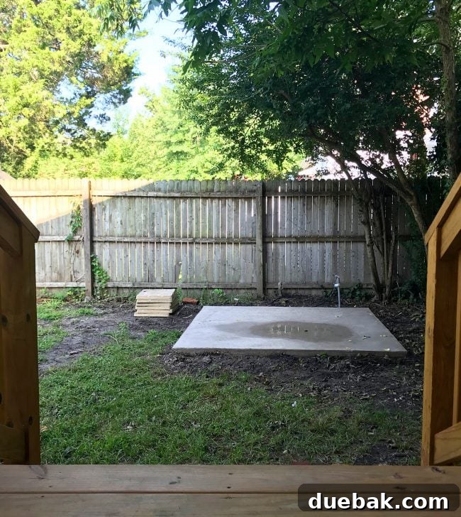 Concrete pad for the hot tub, with stacks of pavers nearby