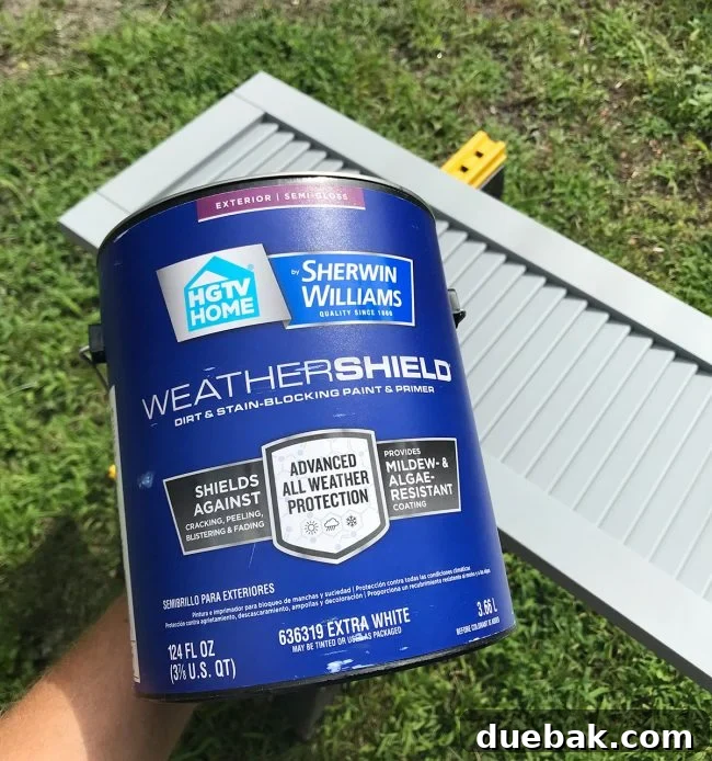 Painting the composite shutters with Weathershield exterior paint, showcasing the DIY process.