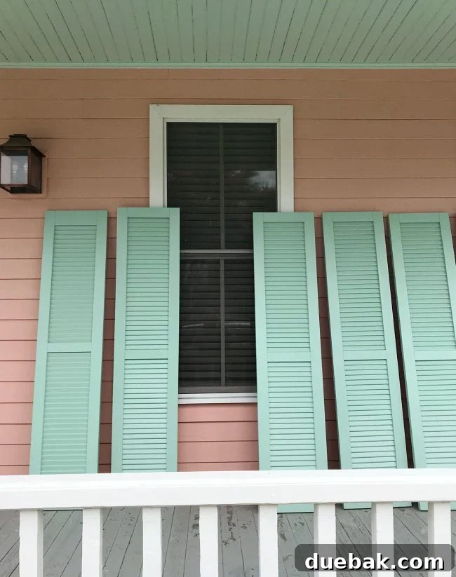 Finished painted shutters in Pale Patina, ready for installation, with a subtle hint of connection to the 'pink house' ceiling color.