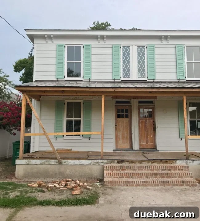 Close-up of the duplex roofline before renovation, showing original corbels and architectural details.