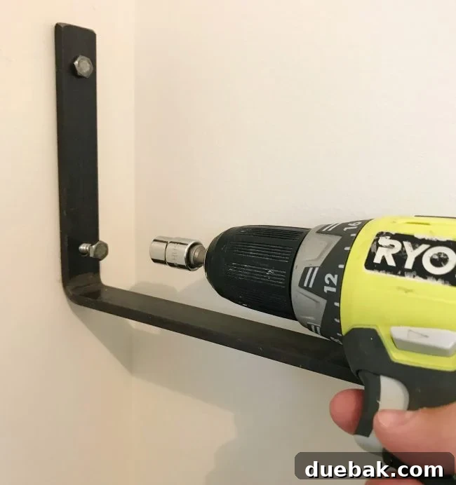 Close-up of screw being driven into a decorative shelf bracket