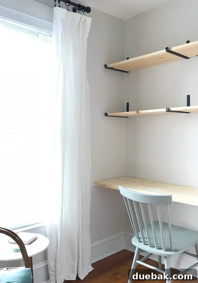 Unstained shelves and desk installed in the small room