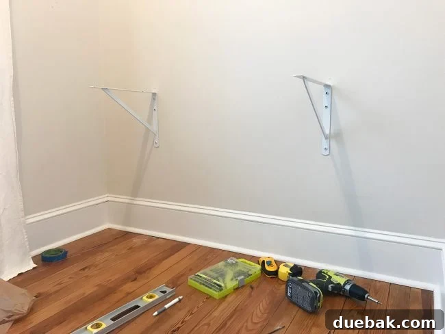Installing heavy-duty white brackets for the DIY desk