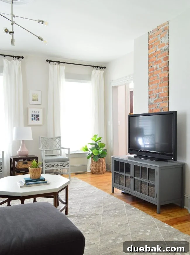 Our Beach House Downstairs: Before and After 37 Renovated living room with exposed brick and coastal decor