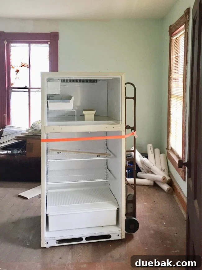 Our Beach House Downstairs: Before and After 38 Living room with fridge and stove before renovation