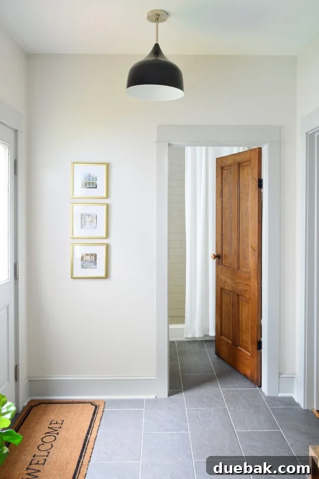 Our Beach House Downstairs: Before and After 47 Renovated mudroom with original door and framed photos