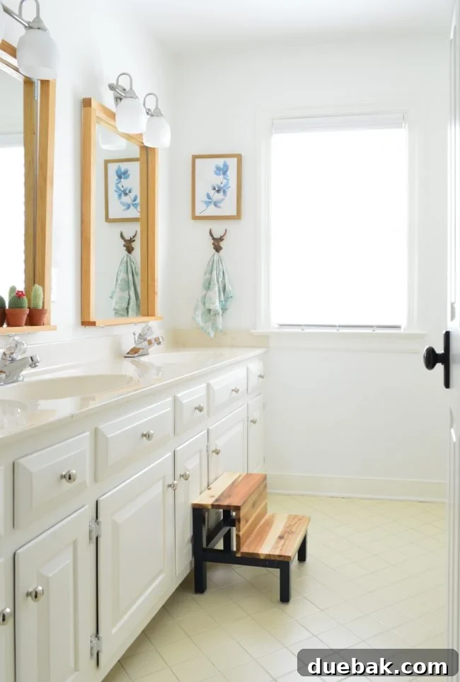 Our Bathroom Disaster 11 After photo of the kids' hall bathroom, looking much brighter and updated with new paint and fixtures.