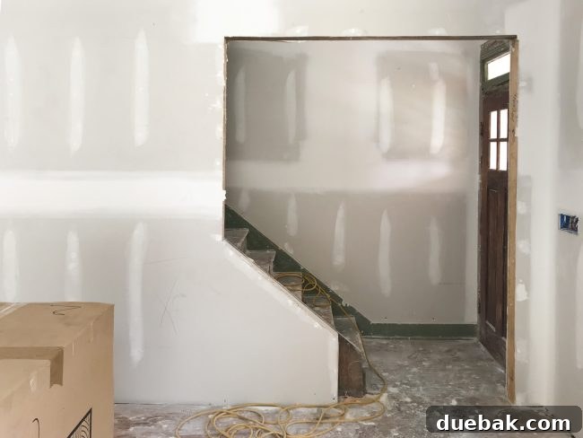 The Duplex Takes Shape Drywall And Video Tour Reveal 11 Opened up stairs and entryway with visible transom window