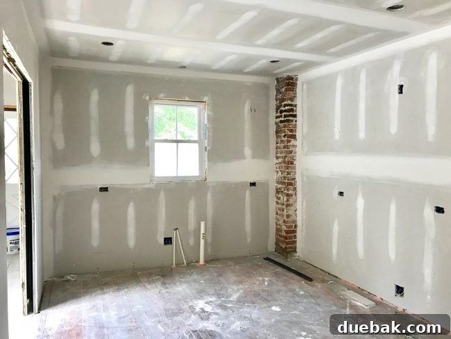 The Duplex Takes Shape Drywall And Video Tour Reveal 9 Kitchen wall with exposed brick chimney