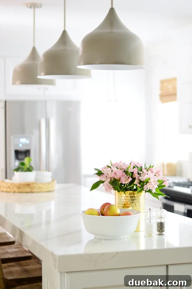 A kitchen island before decluttering, showcasing numerous decorative objects and a more styled aesthetic.