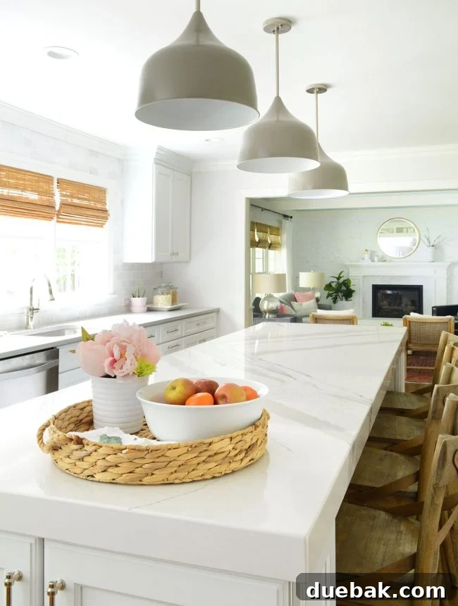 A wider view of a decluttered kitchen island, showing clear sightlines to the living room and a balanced, cozy minimalist design.