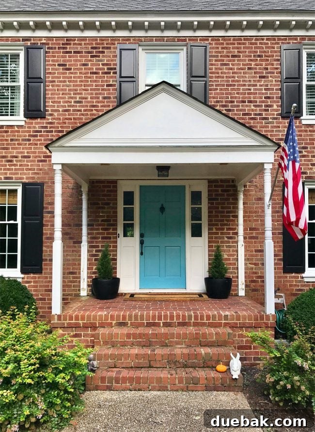 The newly opened front porch after removing the Chippendale railings, showing a wider, more minimalist brick floor and a clearer path.