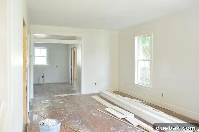Duplex living room painted in Sherwin Williams Spare White with Extra White trim