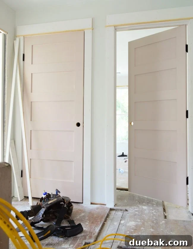 Upstairs bedroom door painted in Sherwin Williams White Truffle (first coat)