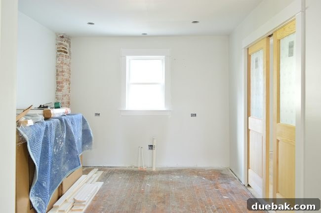 Duplex kitchen showing wide opening to dining room and pocket doors to laundry room