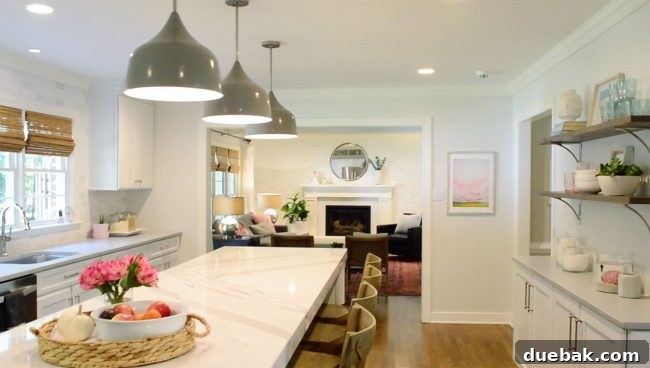 A beautifully updated living room with modern decor and comfortable seating, showcasing the ongoing transformation of the home.