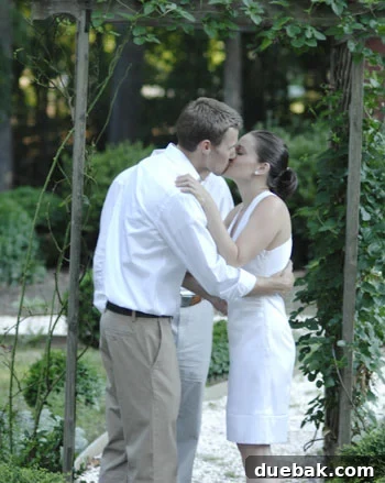 A newlywed couple sharing a kiss, symbolizing partnership and shared life goals, including home decor.